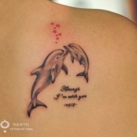 Romantic and sweet colored little dolphins with hearts and lettering tattoo on shoulder
