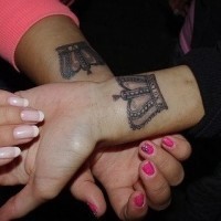 Romantic crown tattoos for couples on hands