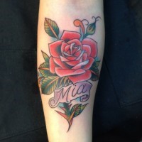 Romantic style colored big rose with lettering tattoo on arm