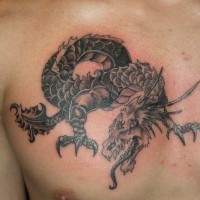 Scaly black dragon tattoo on chest