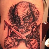 Scary clown with bloody knives tattoo