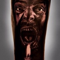 Scary looking colored arm tattoo of screaming man with candle