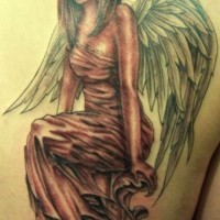 Seated woman angel tattoo on back