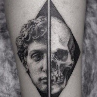 Separated black ink leg tattoo of half human skull with antic statue