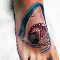 Shark's head with open mouth colored tattoo on foot in realism style