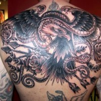 Sharp designed and detailed black and white big eagle tattoo on back combined with snakes and arrows