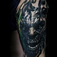 Sharp detailed and colored monster face tattoo on shoulder