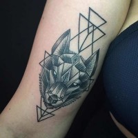 Sharp engraving style black ink wolf head tattoo on arm combined with black triangles
