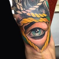 Simple big colored human eye tattoo on arm with rope