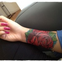 Simple big red colored rose tattoo on arm
