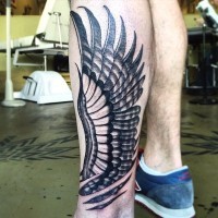 Simple black and white eagle wing tattoo on arm