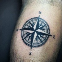 Simple black and white nautical star tattoo on leg