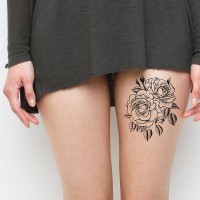 Simple black ink floral tattoo on thigh