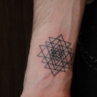 Simple black ink geometrical tattoo on wrist