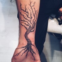 Simple black ink old creepy tree tattoo on wrist