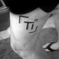 Simple black ink thigh tattoo of chemistry element