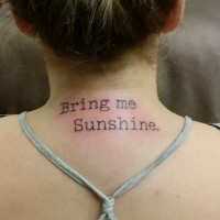 Simple black ink type writer font like lettering tattoo on neck
