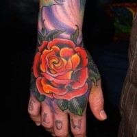 Simple cartoon like colored big rose tattoo on hand