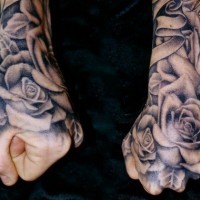 Simple colored big black ink roses on hand tattoo