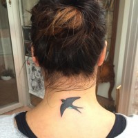 Simple colored little swallow tattoo on neck