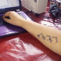 Simple cute gray-ink mammoth family tattoo on arm