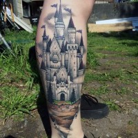 Simple designed beautiful painted colored castle tattoo on leg