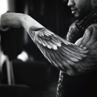 Simple designed big black and white wing tattoo on sleeve