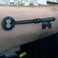 Simple designed big black ink old iron key tattoo on arm