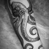 Simple designed big detailed black and white octopus tattoo on arm