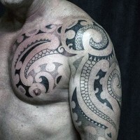 Simple designed black ink Polynesian tattoo on shoulder and chest