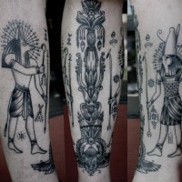 Simple homemade like black and white ancient Egypt themed tattoo on leg