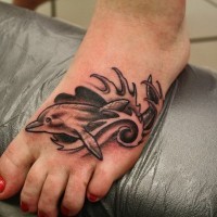 Simple homemade like black ink dolphin tattoo on foot