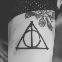 Simple homemade like black ink tattoo on triangle with circle