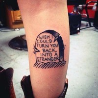 Simple homemade like black ink tombstone with lettering tattoo on leg