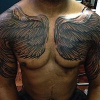 Simple homemade like black ink wings tattoo on chest and shoulders