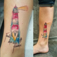 Simple homemade style colored lighthouse tattoo on leg combined with lettering