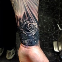Simple iron like black ink rose tattoo on wrist