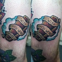 Simple little colored wooden coffin with lettering and ribbon tattoo on thigh