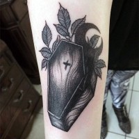 Simple little wooden coffin with cross and moon tattoo on arm