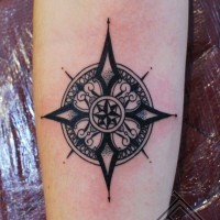 Simple old school black ink star shaped tattoo on arm