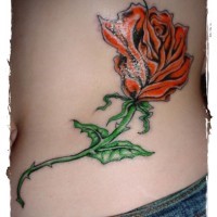 Simple painted and colored rose tattoo on waist