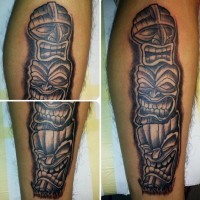 Simple painted and colored smiling masks tribal tattoo on leg