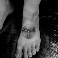 Simple painted little black ink zodiac symbol tattoo on foot