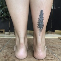 Simple painted tiny black ink ankle tattoo of lonely tree