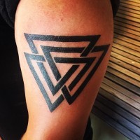 Simple painted tribal style black ink triangle shaped tattoo on upper arm