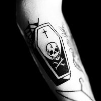 Simple tiny black and white coffin stylized with skull and cross tattoo on arm