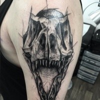 Sketch style black ink shoulder tattoo of dinosaur skull