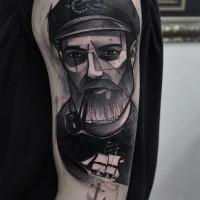 Sketch style black ink shoulder tattoo of smoking sailor with beard