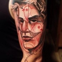 Sketch style colored shoulder tattoo of mans face