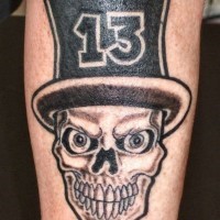 Skull in a hat with number thirteen tattoo